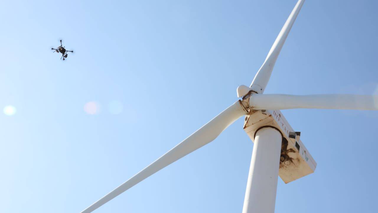 This is a photo of one of our drones inspecting a wind turbine.